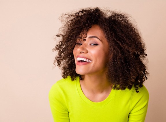 Woman smiling in yellow shirt